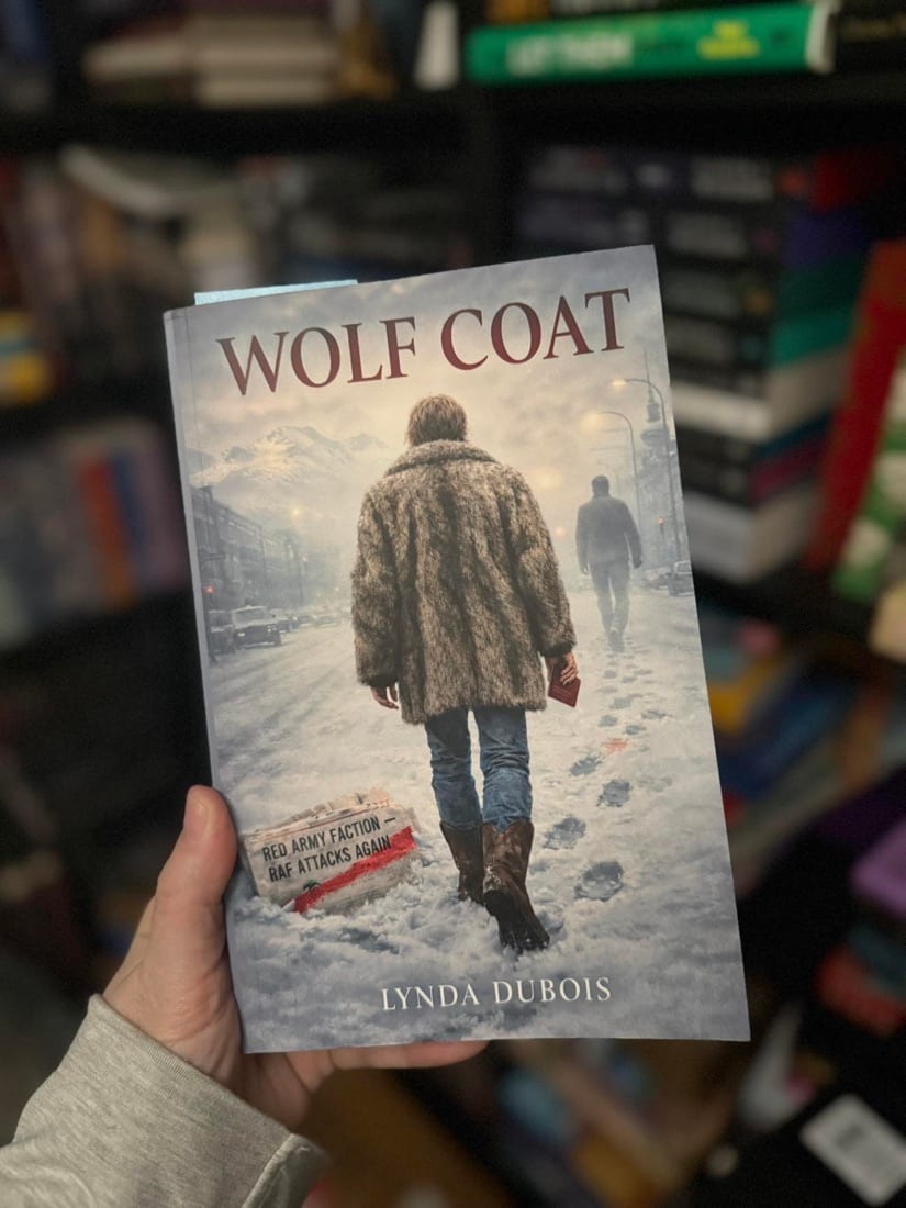 The Wolf Coat paperback held up in a bookshop